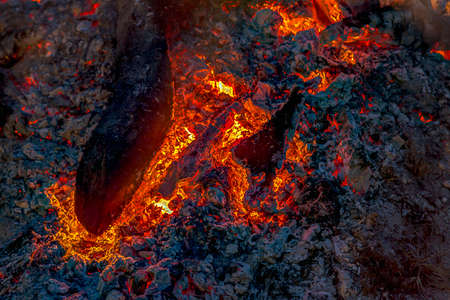 Hot coals glow in the night offering warmth and comfortの写真素材