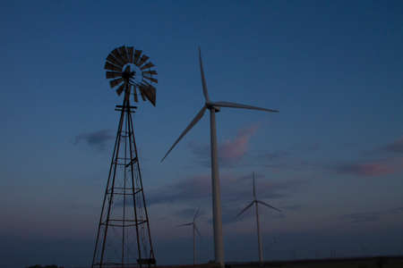 The old and the new windmills both reach for the windの写真素材