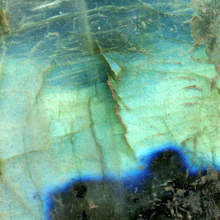 Labradorite, a mineral stone. It is a beautiful iridescent piece. The gemstone is full screen. Light green blue and black colors.の写真素材