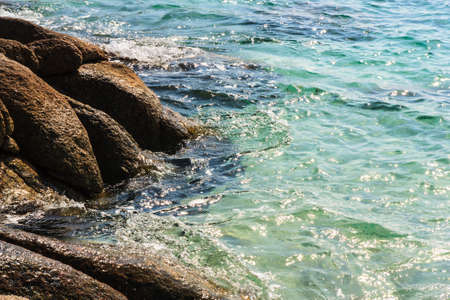Sea and stone in sunrise day, Mon-nok Island, Thailandの写真素材