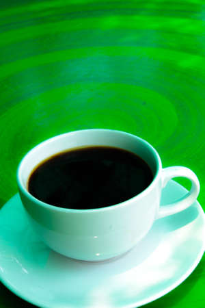 Cup of black coffee on green backgroundの写真素材