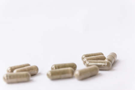 Herbs capsules on white backgroundの写真素材