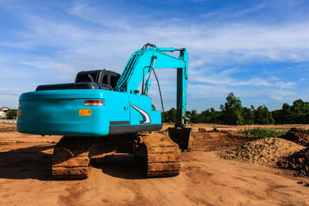 Modern blue excavator machines with blue backgroundの写真素材