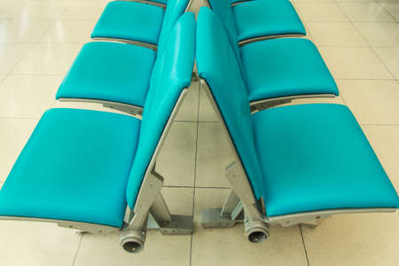 Row of blue seats in waiting airport roomの写真素材