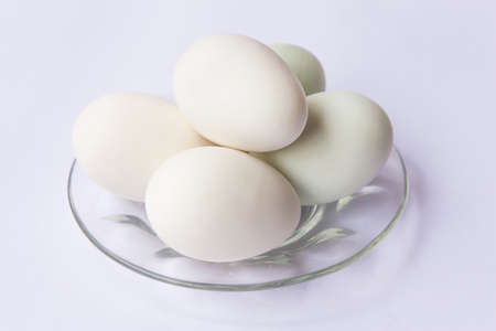 preserved duck eggs on plate isolate on white background