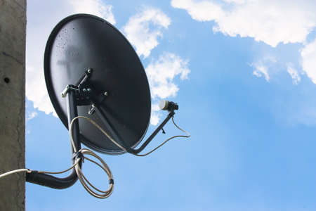 Satellite television aerial on  blue backgroundの写真素材