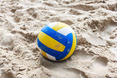 Volleyball on empty beach in twilightの写真素材