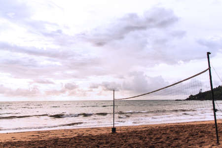 Volleyball net on empty beach in twilight