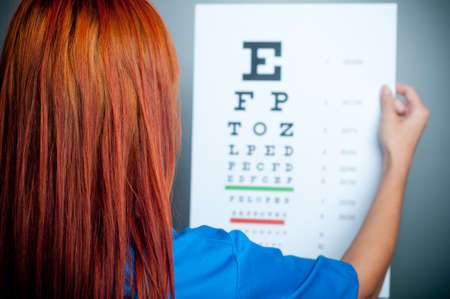 a doctor watching a test for eye examinationの写真素材