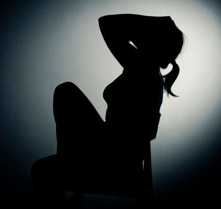 sad woman sitting alone in a empty roomの写真素材