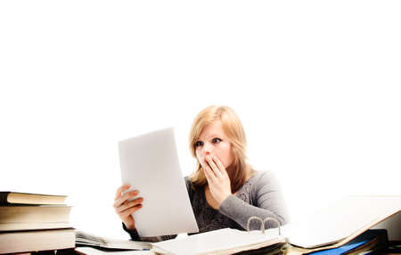 Stressed student revising for an exam - isolated on white backgrgroundの写真素材