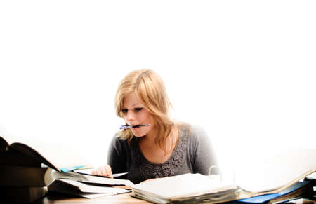 Stressed student revising for an exam - isolated on white backgrgroundの写真素材