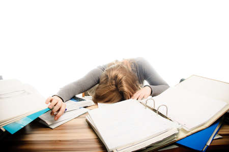 Stressed student revising for an exam - isolated on white backgrgroundの写真素材