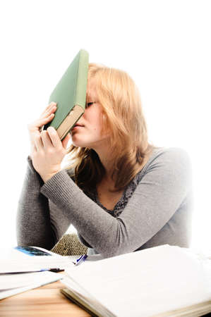 Stressed student revising for an exam - isolated on white backgrgroundの写真素材