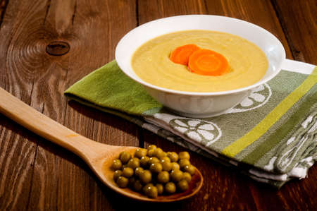 Bowl with green bean soup, on a wooden backgroundの写真素材