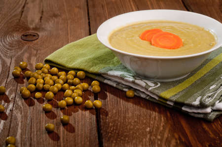 Bowl with green bean soup, on a wooden backgroundの写真素材