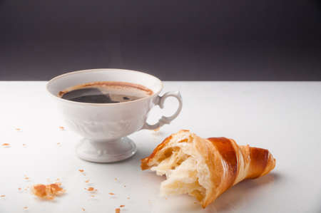 Croissant and a cup of delicious coffeeの写真素材