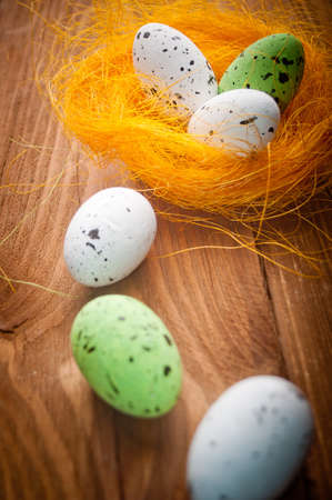Easter eggs in nest on rustic wooden planksの写真素材