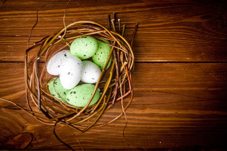Easter eggs in nest on rustic wooden planksの写真素材