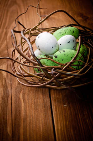 Easter eggs in nest on rustic wooden planksの写真素材