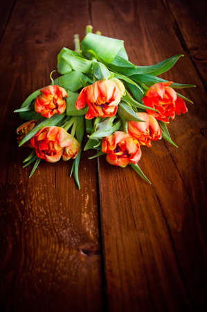 Tulips on rustic wooden tableの写真素材