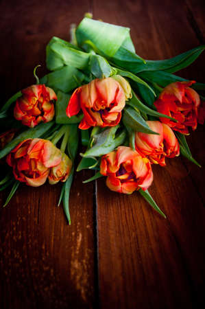 Tulips on rustic wooden tableの写真素材