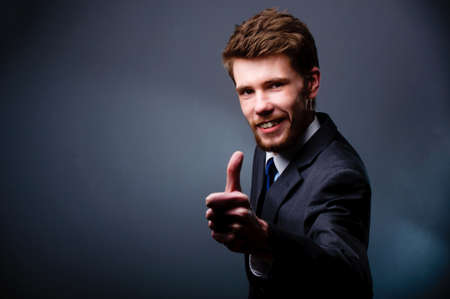 Smiling businessman with thumbs upの写真素材