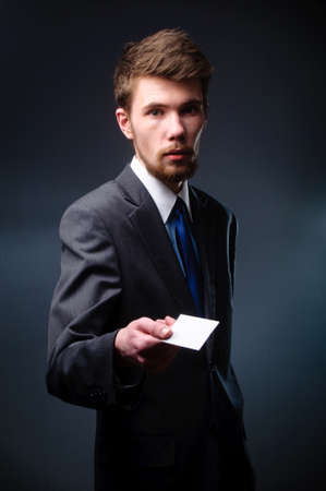 Business man handing a blank business cardの写真素材