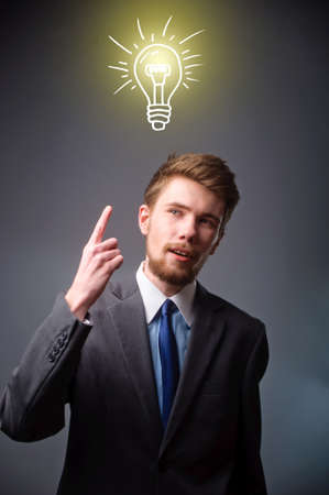 Young businessman with thoughtful expression and light bulb over his head