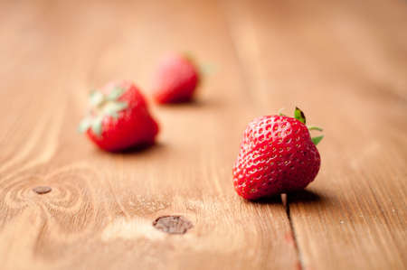 fresh strawberries on a wooden backgroundの写真素材