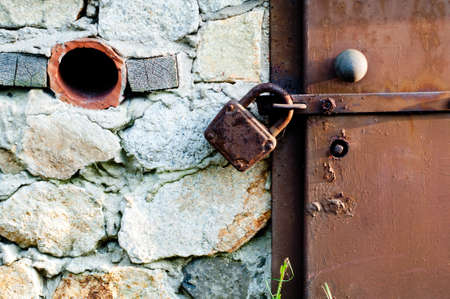 Closeup metal door with lock in grungy styleの写真素材