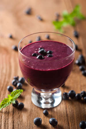 Glass of fresh blueberry smoothie with blueberriesの写真素材