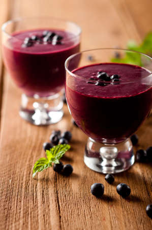Glass of fresh blueberry smoothie with blueberriesの写真素材