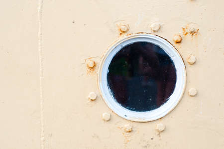 Porthole on the  wall of the old shipの写真素材