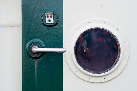 Porthole on the  wall of the old ship