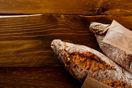 Wholemeal bread on a wooden tableの写真素材