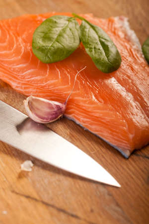 fresh salmon on wooden chopping boardの写真素材