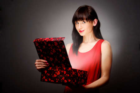 Beautiful brunette opens giftの写真素材