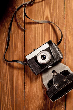Vintage camera on wooden background