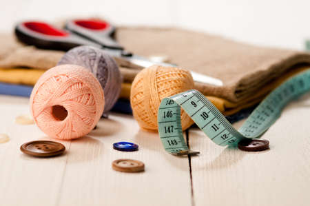 Sewing with color threads, meter and scissors