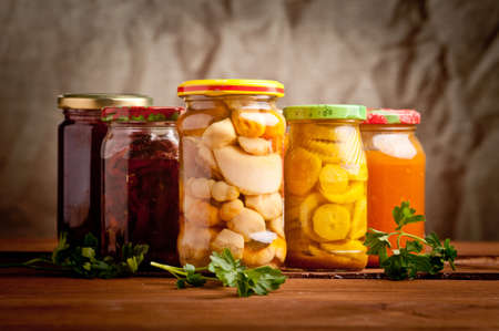 Composition with jars of pickled vegetables. Marinated food.の写真素材
