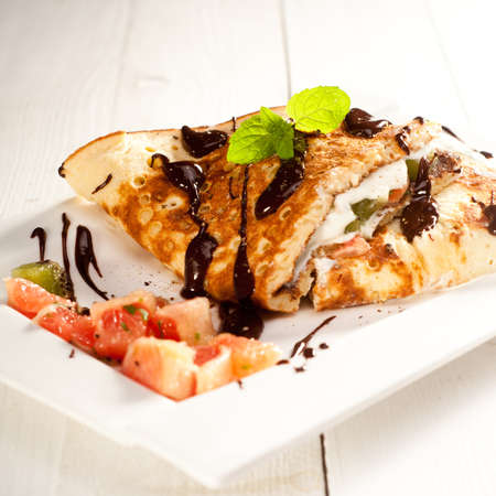 Sponge Pancakes with cheese, fruit, chocolate and mintの写真素材