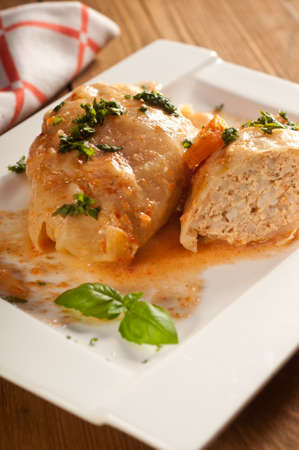 Closeup of stuffed cabbage rolls with tomato souce and herbsの写真素材