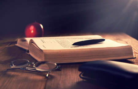 Old book on the wooden boards. Retouching Vintage, selective focus.の写真素材