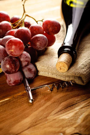Red wine and grapes in vintage settingの写真素材