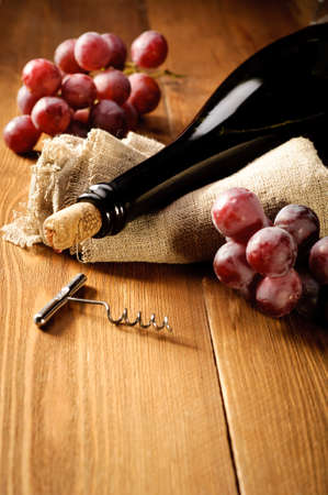Red wine and grapes in vintage settingの写真素材