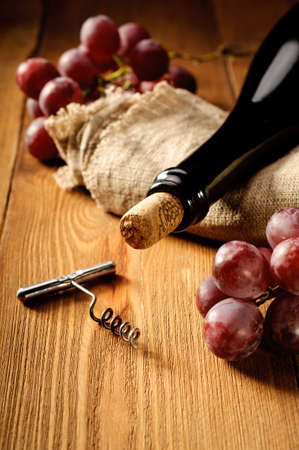 Red wine and grapes in vintage settingの写真素材