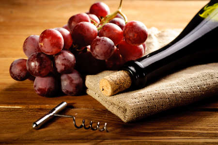 Red wine and grapes in vintage settingの写真素材