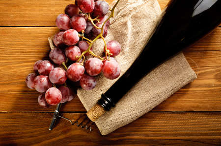 Red wine and grapes in vintage settingの写真素材