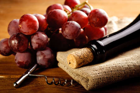 Red wine and grapes in vintage settingの写真素材